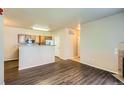 Open-concept living area flowing into the kitchen, featuring modern wood floors at 8083 W 51St Pl # 203, Arvada, CO 80002