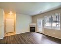 Inviting living room with wood floors, fireplace, and lots of natural light at 8083 W 51St Pl # 203, Arvada, CO 80002