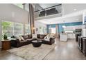 Spacious living room featuring high ceilings, large windows, and an open floor plan at 13132 Pennsylvania Cir, Thornton, CO 80241