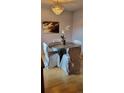 Charming dining room with an elegant chandelier and a rustic round table with covered chairs at 911 Laramie Blvd # B, Boulder, CO 80304