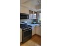 Well-equipped kitchen featuring modern appliances, light cabinets, and a tiled backsplash at 911 Laramie Blvd # B, Boulder, CO 80304