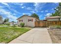 Side view of a home with a fenced-in yard and a long driveway to detached garage at 3451 Highland Pl, Westminster, CO 80031