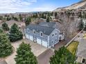 Spacious four-car garage with blue siding, white trim, and a large driveway, perfect for car enthusiasts at 5753 Secrest Ct, Golden, CO 80403