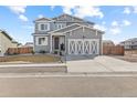 Charming two-story home with gray siding, white accents, and a well-manicured front yard at 601 Tenderfoot Dr, Berthoud, CO 80513