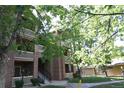 A multi-story condo building featuring exterior brick, siding and inviting balconies at 1631 W Canal Cir # 832, Littleton, CO 80120