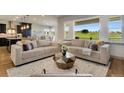 Bright living room with large windows, hardwood floors, and an open concept design at 17637 W 87Th Ave, Arvada, CO 80007