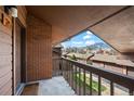 Balcony with mountain views, brick wall, and wood railing at 501 Manhattan Dr # 202, Boulder, CO 80303