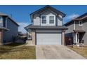 Charming two-story home with gray siding, brick accents, and a two-car garage on a sunny day at 8819 Cloverleaf Cir, Parker, CO 80134