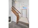 Inviting foyer with staircase, fireplace, neutral tile floors and natural light at 8819 Cloverleaf Cir, Parker, CO 80134