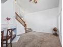 Open living room with fireplace, staircase, carpeted floor, and lots of natural light at 8819 Cloverleaf Cir, Parker, CO 80134
