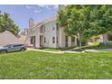 Inviting townhome with lush green lawn, a deck, and a quaint walking path at 1005 S Miller St # 102, Lakewood, CO 80226