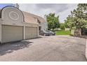 Exterior view of the townhome highlighting the two-car garage and ample parking at 1005 S Miller St # 102, Lakewood, CO 80226
