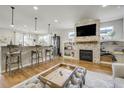 Stylish living room featuring a stone fireplace, built-in shelves, and an open floor plan at 4425 Quitman St, Denver, CO 80212