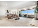 Bright and airy living room with sliding glass doors to a balcony with mountain views at 11541 Quartzite Way, Parker, CO 80138