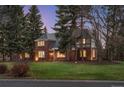 The house is surrounded by mature trees and has a beautiful lawn at 7 Cherry Hills Farm Dr, Cherry Hills Village, CO 80113