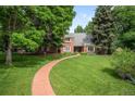 Beautiful brick home with a curved brick walkway and a spacious, manicured lawn at 7 Cherry Hills Farm Dr, Cherry Hills Village, CO 80113