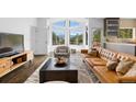 Bright living room with modern furnishings, a large picture window showcasing mountain views, and an open floor plan at 58 Stagecoach Blvd, Evergreen, CO 80439