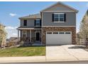 Charming two-story home with stone accents, a two-car garage, and a well-manicured lawn at 6024 High Timber Cir, Castle Rock, CO 80104