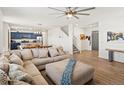 Open-concept living room with hardwood floors seamlessly flowing into the modern kitchen at 6024 High Timber Cir, Castle Rock, CO 80104