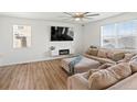 Bright living room with hardwood floors, fireplace, and a comfortable sectional sofa at 6024 High Timber Cir, Castle Rock, CO 80104