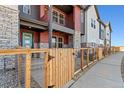 Beautiful townhome showcases colorful siding, stone accents, and a fenced front yard at 2849 E 103Rd Dr, Thornton, CO 80229