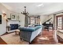 Living room with hardwood floors, fireplace, chandelier and large windows providing ample natural light at 2825 E 9Th Ave, Denver, CO 80206