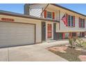 Attractive home with a two-car garage, brick accents, and vibrant red window shutters at 1207 S Memphis St, Aurora, CO 80017