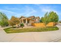 Attractive home with a cozy front porch and well-manicured landscaping at 4850 Bluegate Ln, Highlands Ranch, CO 80130