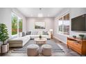 Bright living room featuring neutral décor, large windows, and comfortable seating at 4850 Bluegate Ln, Highlands Ranch, CO 80130