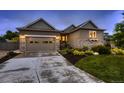 Charming single Gathering home featuring stone accents, attached garage and well maintained lawn at 6652 W Asbury Pl, Lakewood, CO 80227