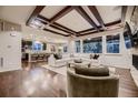 Spacious open concept living room featuring a modern coffered ceiling and hardwood floors at 6652 W Asbury Pl, Lakewood, CO 80227