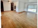 Bright living room featuring hardwood floors, large window, and built-in shelving at 4549 S Acoma S St, Englewood, CO 80110