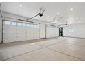 Spacious three car garage with clean lines and a well-lit interior, perfect for storage and vehicles at 49601 E 56Th Ave, Bennett, CO 80102