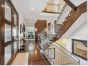 Inviting foyer with hardwood floors, soaring ceilings, and a staircase with metal railings at 230 Hudson St, Denver, CO 80220