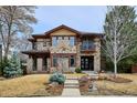 Charming two-story stone home with a balcony and well-maintained landscaping at 230 Hudson St, Denver, CO 80220