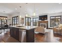 Open kitchen with stainless steel appliances, island with seating, and access to the living area at 230 Hudson St, Denver, CO 80220