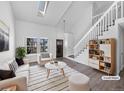 Bright living room featuring vaulted ceilings, skylights, and modern finishes at 4658 E 107Th Ave, Thornton, CO 80233
