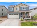 Attractive two-story house with a covered front porch, landscaped yard, and a convenient two-car garage at 9375 Joyce Way, Arvada, CO 80007