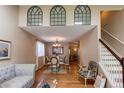 Open-concept living room and dining area with hardwood floors and natural light at 6687 Devinney Ct, Arvada, CO 80004