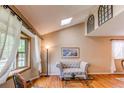 Sun-filled living room with vaulted ceiling, hardwood floors and stylish decor at 6687 Devinney Ct, Arvada, CO 80004