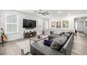 Open living area with modern decor, hardwood floors, and plenty of natural light at 8175 Sewanee Peak St, Littleton, CO 80125