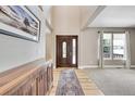 Bright entryway with hardwood floors, a wooden console table, and large windows at 7999 S Blackstone Pkwy, Aurora, CO 80016
