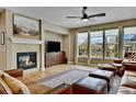 Spacious living room with a fireplace and comfortable leather furniture at 7999 S Blackstone Pkwy, Aurora, CO 80016