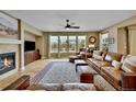Living room with fireplace, hardwood floors, and a large window view at 7999 S Blackstone Pkwy, Aurora, CO 80016