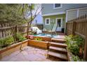 Private outdoor patio featuring stone floor, lush foliage, a seating area and privacy fence at 10735 W Dartmouth Ave, Lakewood, CO 80227