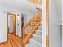 Bright entryway featuring hardwood floors, carpeted stairs, and modern lighting at 12089 W Chenango Dr, Morrison, CO 80465