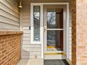 Inviting front door with glass, sidelight window, and secure Ring doorbell system at 12089 W Chenango Dr, Morrison, CO 80465