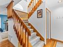 Carpeted staircase with wooden railing, leading to the upper level and rooms at 12089 W Chenango Dr, Morrison, CO 80465