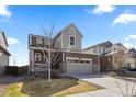 Charming two-story home with a well-manicured lawn, gray siding and a two-car garage at 432 N Patsburg St, Aurora, CO 80018