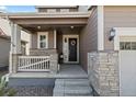 A cozy front porch with stone accents leads to the front door, creating a welcoming entrance at 432 N Patsburg St, Aurora, CO 80018